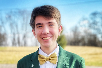 Young man dressed in green business jacket smiling