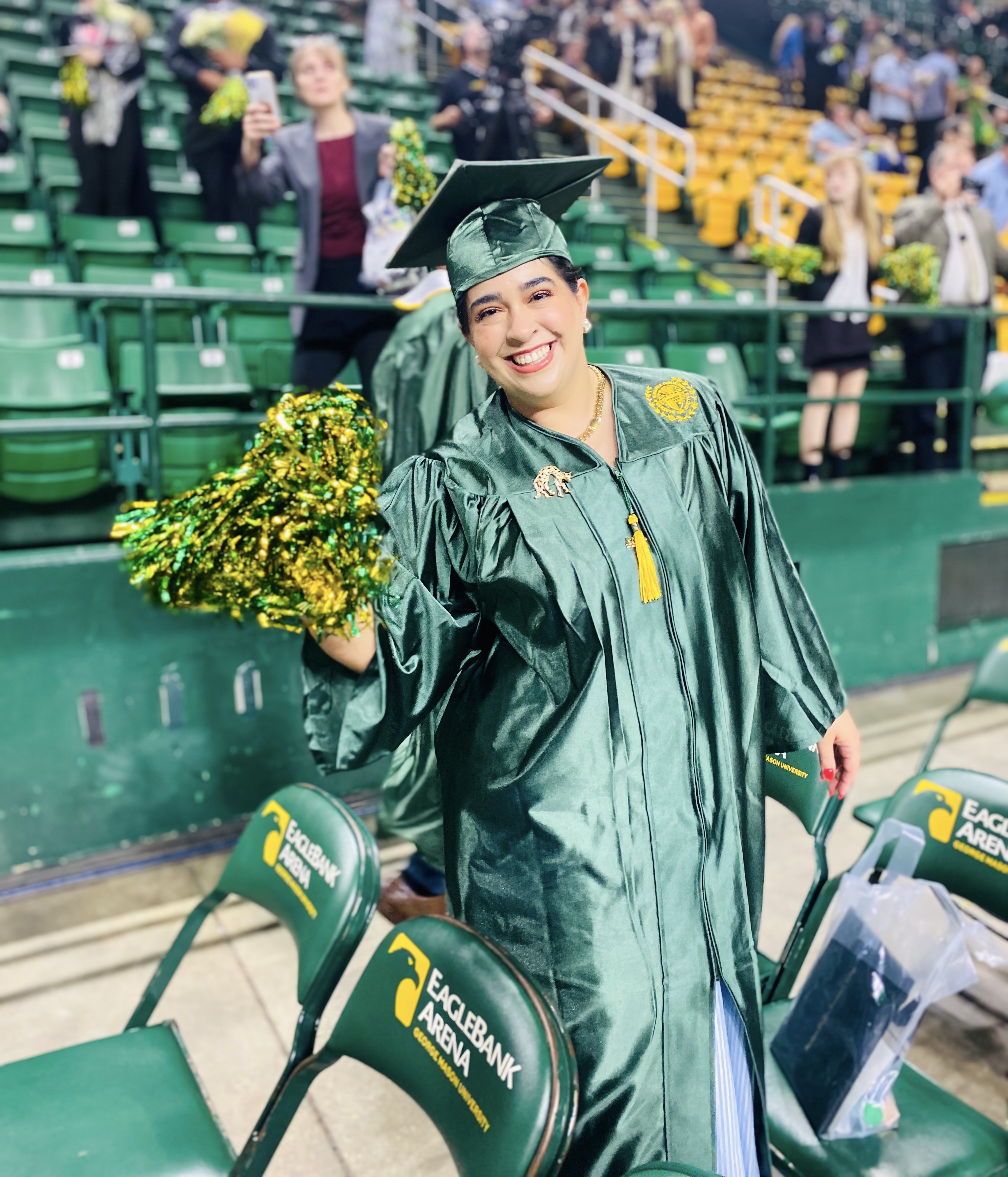 Nour Alamiri waves a green and gold pom pom in celebration of her big day!